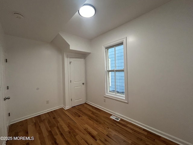 bonus room with visible vents, baseboards, and wood finished floors