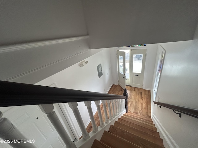 stairway featuring baseboards and wood finished floors
