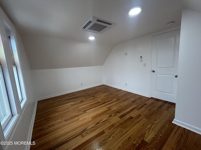bonus room featuring dark wood-style flooring, baseboards, recessed lighting, and lofted ceiling