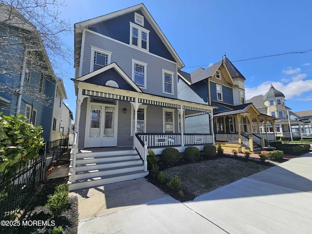 view of front of home with covered porch and fence