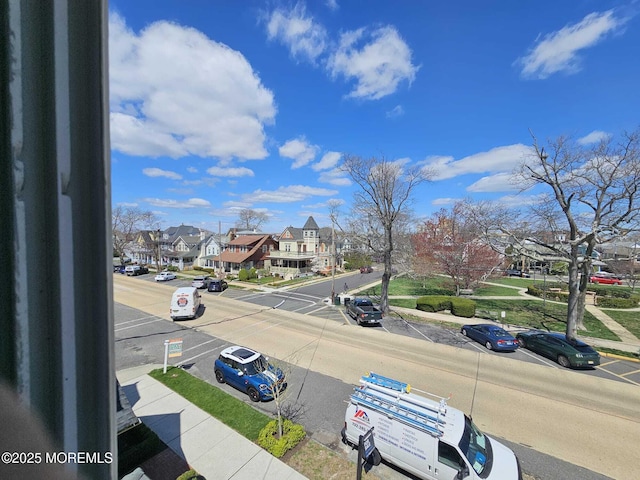 view of road featuring sidewalks, curbs, and a residential view
