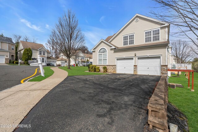1 Kushnetki Rd, Parlin, NJ 08859 - traditional-style home with driveway, a front yard, stone siding, an attached garage, and a residential view
