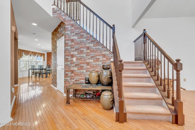 1 Kushnetki Rd, Parlin, NJ 08859 - stairway with baseboards, recessed lighting, brick wall, and wood-type flooring