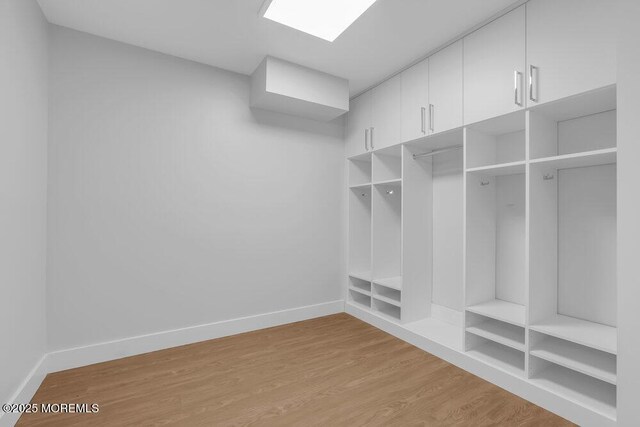 mudroom featuring light wood-type flooring and baseboards