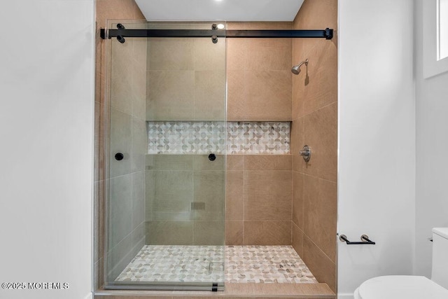 full bath with a shower stall and toilet