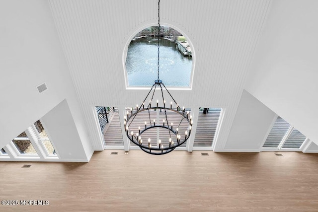 room details with visible vents, an inviting chandelier, and wood finished floors