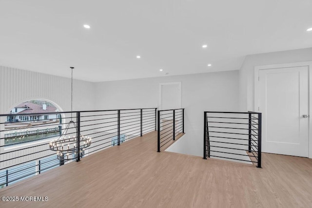 spare room featuring recessed lighting, a chandelier, and wood finished floors