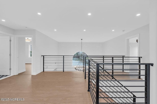 corridor featuring recessed lighting, an upstairs landing, baseboards, and wood finished floors