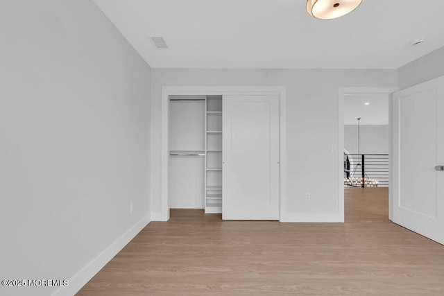 unfurnished bedroom featuring visible vents, baseboards, and light wood finished floors
