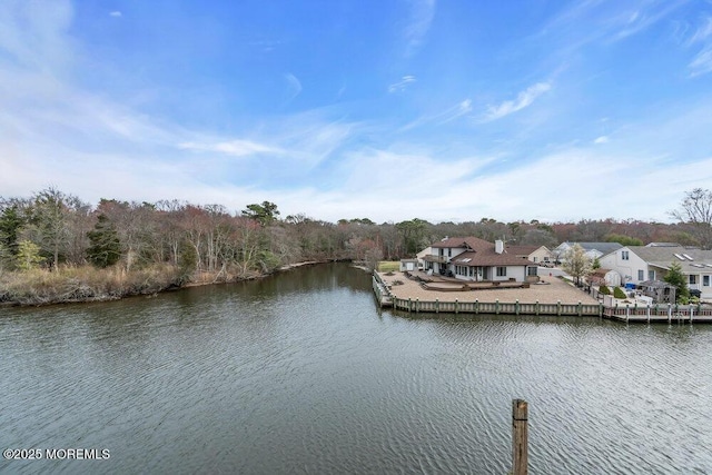 exterior space featuring a deck with water view