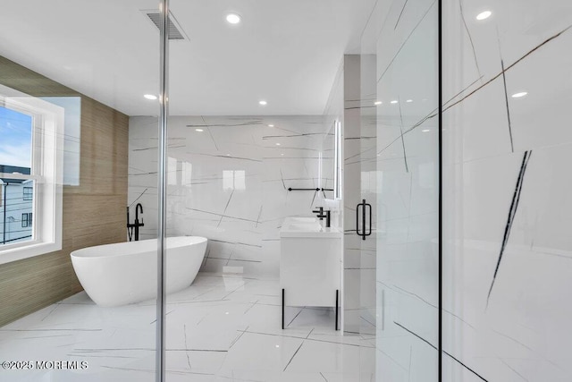 full bath featuring tile walls, a marble finish shower, visible vents, a freestanding bath, and marble finish floor