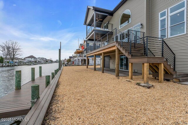exterior space featuring a water view and stairs