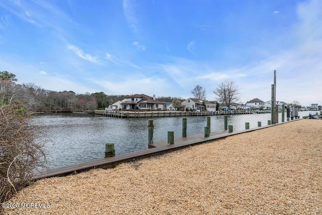 dock area with a water view and a residential view
