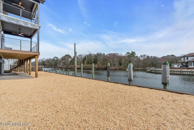 view of yard featuring stairs and a water view