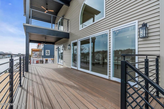 wooden terrace with a ceiling fan