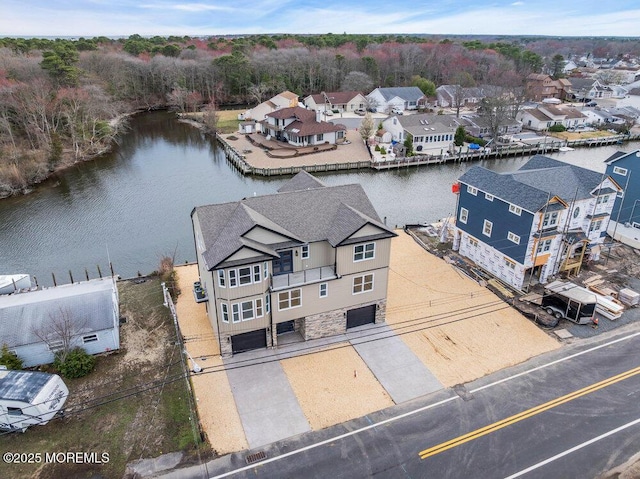 birds eye view of property featuring a water view and a residential view