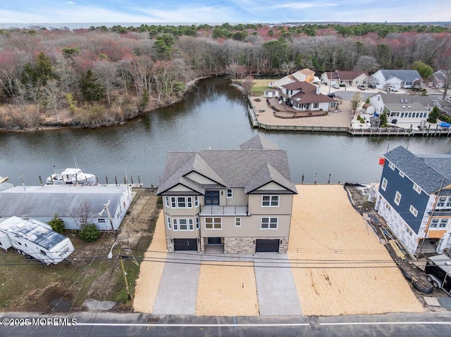 birds eye view of property featuring a water view and a residential view