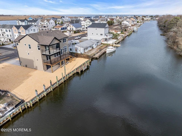 bird's eye view with a water view and a residential view