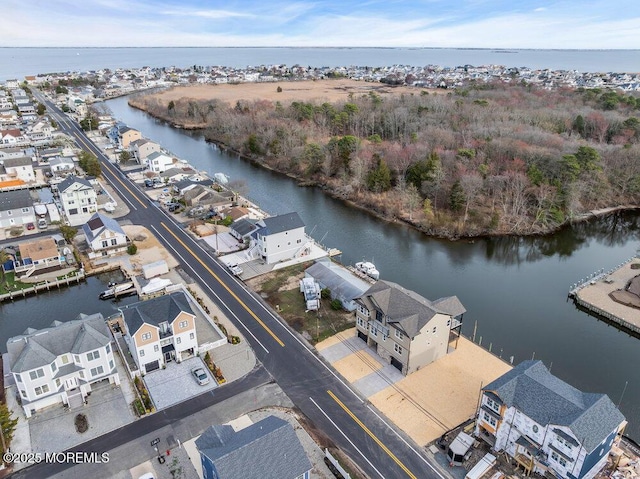birds eye view of property with a water view and a residential view