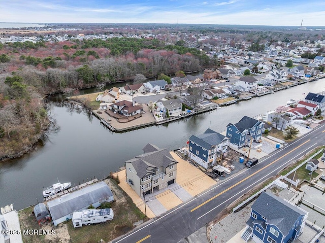 drone / aerial view featuring a water view and a residential view