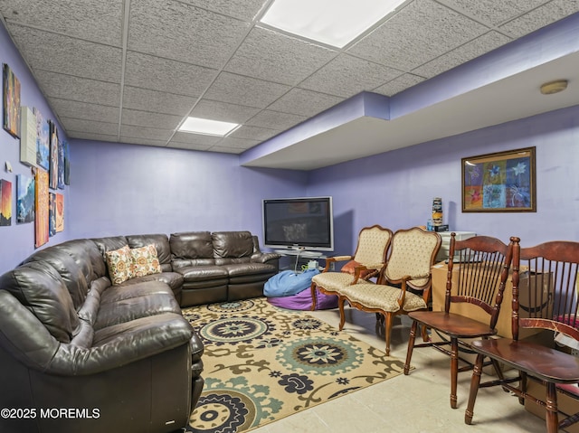 living room featuring a drop ceiling