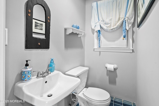 bathroom with toilet and a sink
