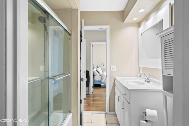 bathroom with tile patterned flooring, ensuite bath, a shower with shower door, vanity, and recessed lighting