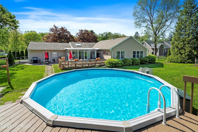 outdoor pool featuring a yard and a deck