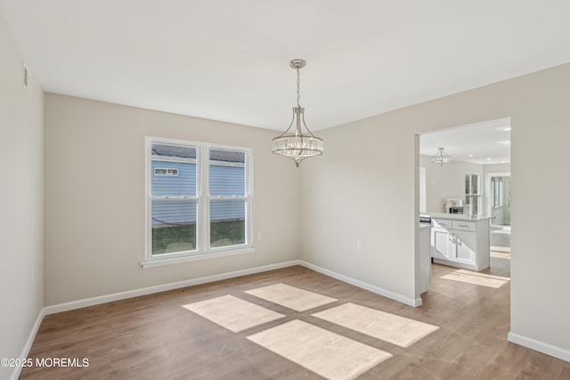 9 Weybridge Pl, Manchester, NJ 08759 - unfurnished room featuring a chandelier, light wood finished floors, and baseboards