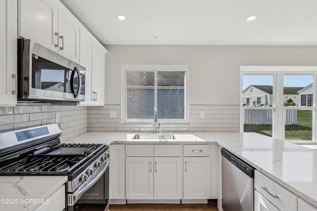9 Weybridge Pl, Manchester, NJ 08759 - kitchen featuring appliances with stainless steel finishes, a sink, decorative backsplash, white cabinets, and recessed lighting