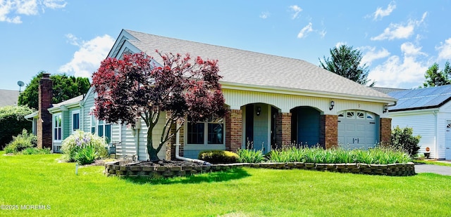9 Weybridge Pl, Manchester, NJ 08759 - view of front of home featuring a front lawn, an attached garage, brick siding, roof with shingles, and driveway