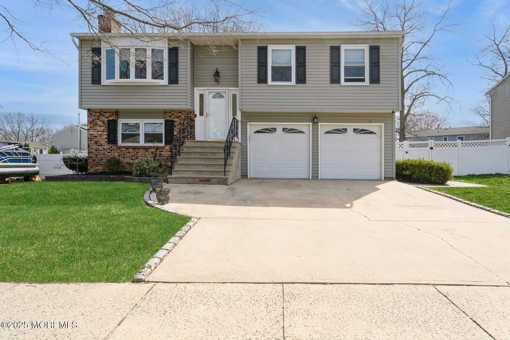 13 Ivy Pl, Howell, NJ 07731 - raised ranch featuring fence, a chimney, a garage, a front yard, and driveway