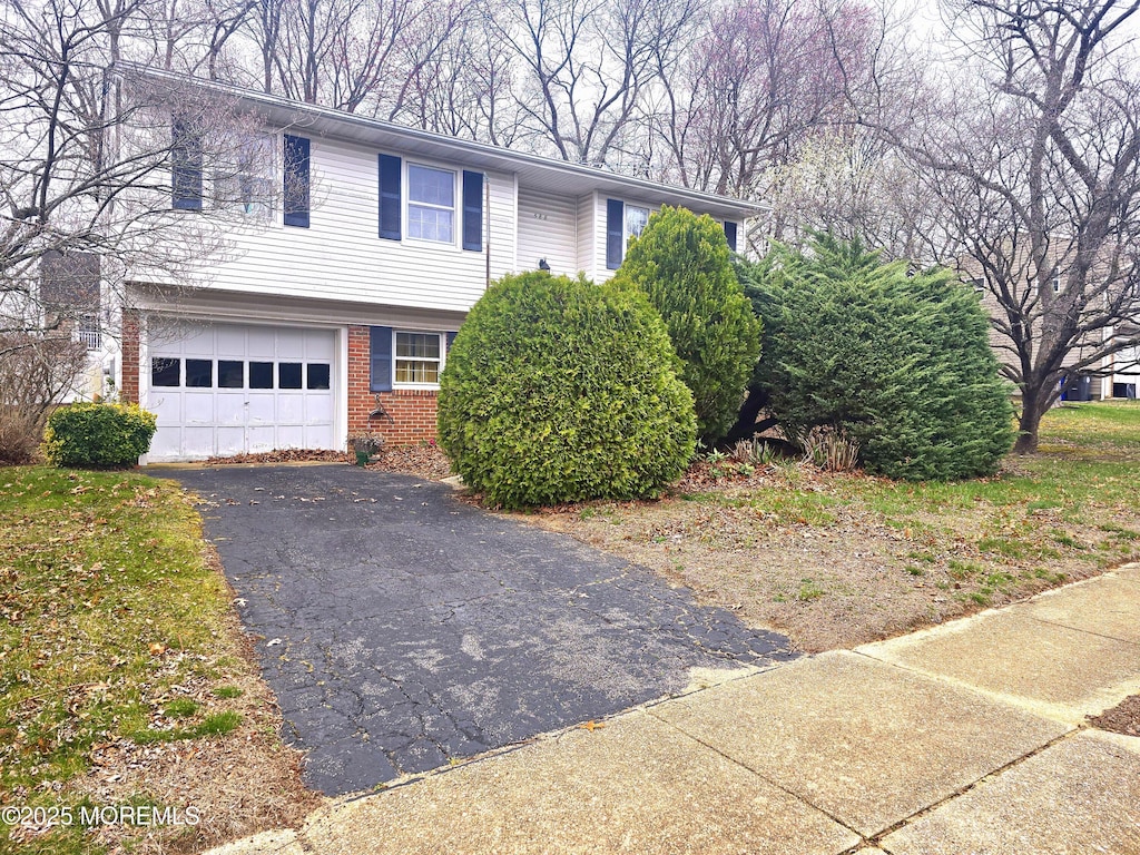 588 Pennsylvania Ave, Brick, NJ 08724 - split foyer home featuring brick siding, driveway, and a garage