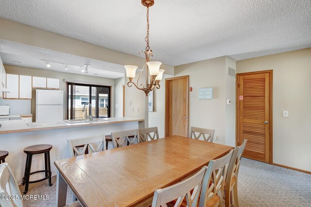 21 Brown Ave Unit 1, Lavallette, NJ 08735 - dining room with a textured ceiling, light colored carpet, a notable chandelier, and visible vents