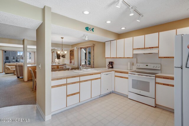 21 Brown Ave Unit 1, Lavallette, NJ 08735 - kitchen with a notable chandelier, a sink, light countertops, white appliances, and under cabinet range hood
