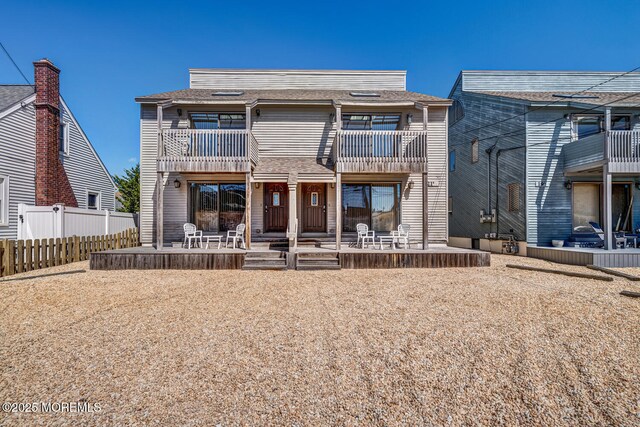 21 Brown Ave Unit 1, Lavallette, NJ 08735 - view of front facade with a shingled roof, fence, and a balcony