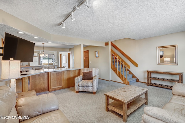 21 Brown Ave Unit 1, Lavallette, NJ 08735 - living area featuring track lighting, baseboards, a textured ceiling, stairway, and light colored carpet