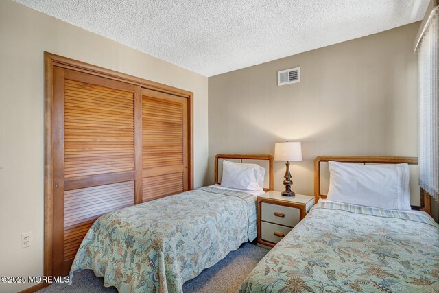 21 Brown Ave Unit 1, Lavallette, NJ 08735 - carpeted bedroom with a textured ceiling, a closet, and visible vents