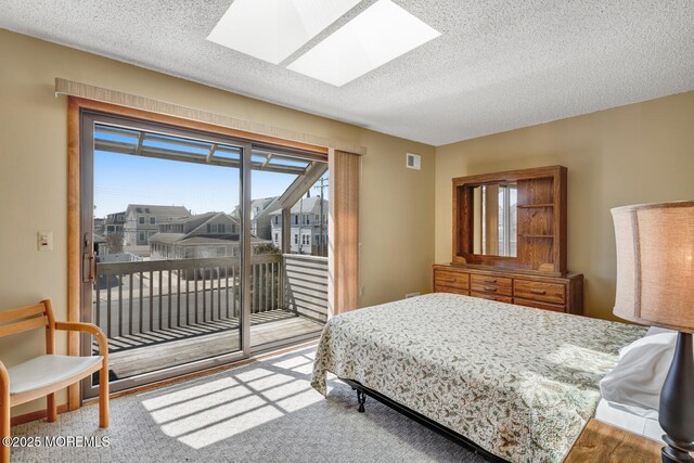 21 Brown Ave Unit 1, Lavallette, NJ 08735 - bedroom with a textured ceiling, visible vents, carpet floors, a skylight, and access to exterior