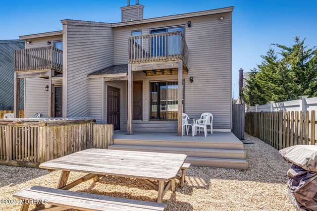 21 Brown Ave Unit 1, Lavallette, NJ 08735 - rear view of property featuring a balcony, fence, and a chimney