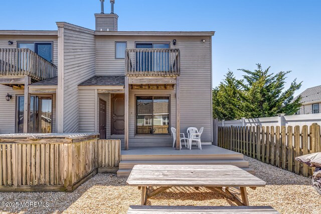 21 Brown Ave Unit 1, Lavallette, NJ 08735 - rear view of property with a chimney, fence, and a balcony