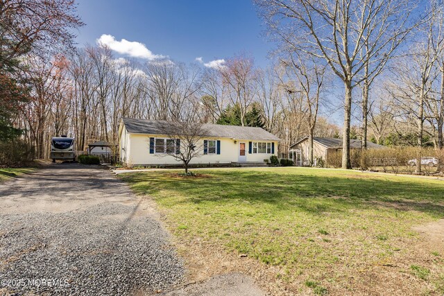 ranch-style home with driveway and a front yard