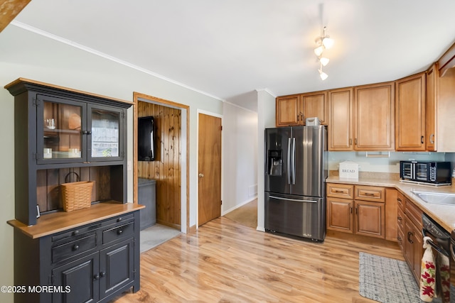 kitchen with black appliances, light wood-style flooring, light countertops, and brown cabinetry