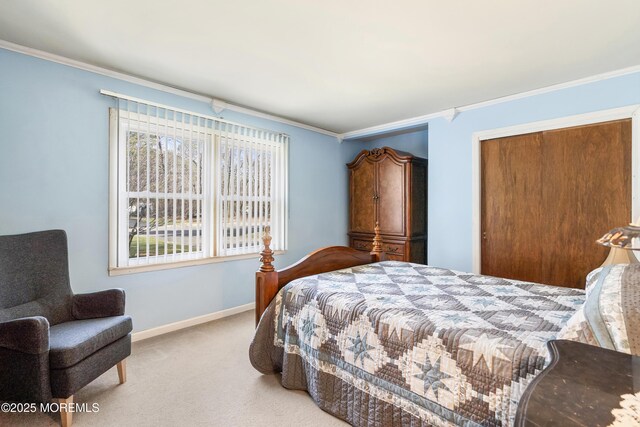 bedroom with a closet, carpet, baseboards, and crown molding