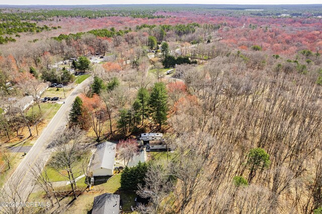 birds eye view of property with a forest view