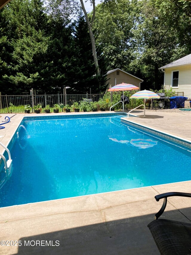 view of pool featuring a fenced in pool, fence, and a patio area