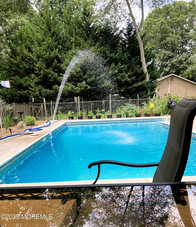 view of swimming pool featuring fence and a fenced in pool