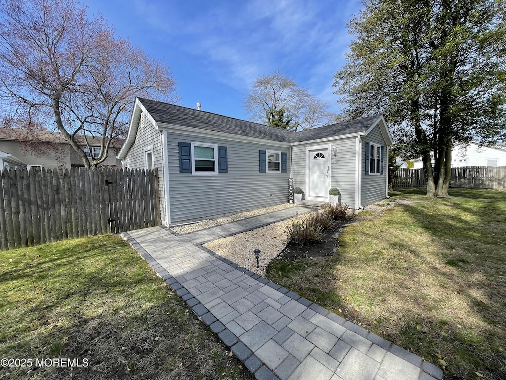 434 1st Ave, Brick, NJ 08724 - bungalow-style home with a front yard and fence