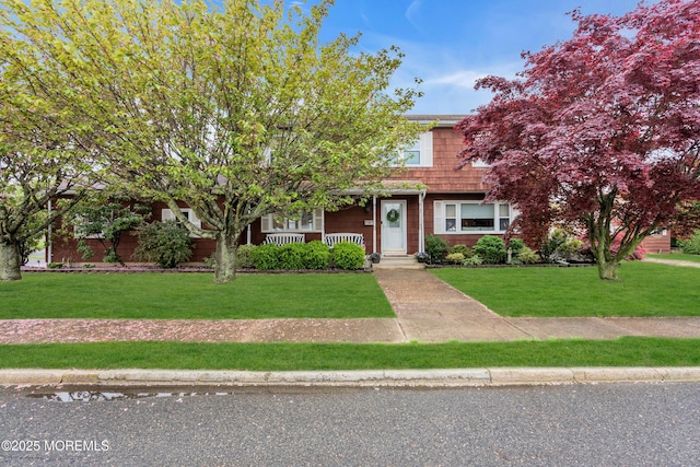view of front of property featuring covered porch and a front lawn