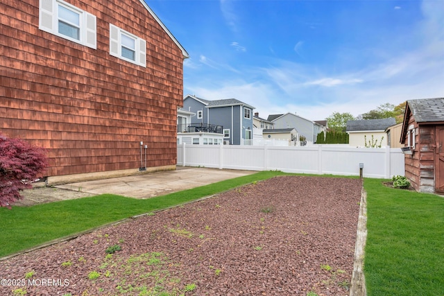 view of yard with a patio, a residential view, and fence